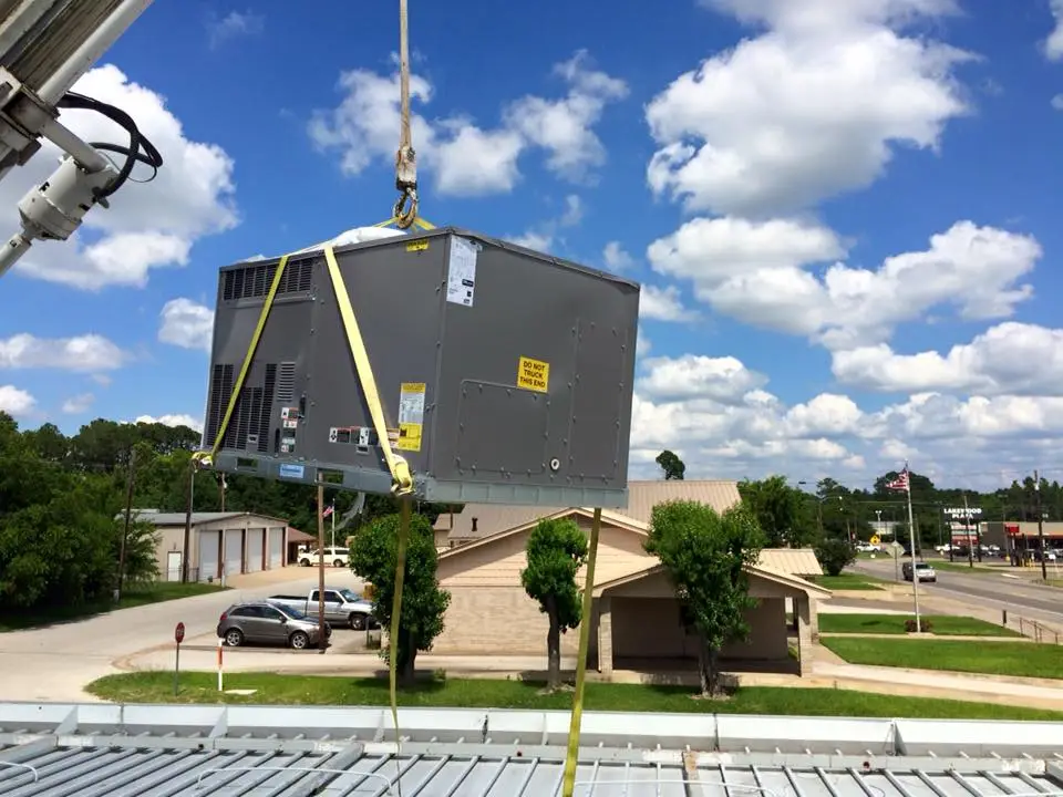 New rooftop getting craned to the roof to be installed by ACM Mechanical Inc
